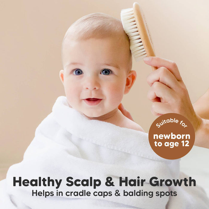 Baby smiling while getting a soothing hair grooming with KeaBabies hairbrush for healthy scalp and hair growth.