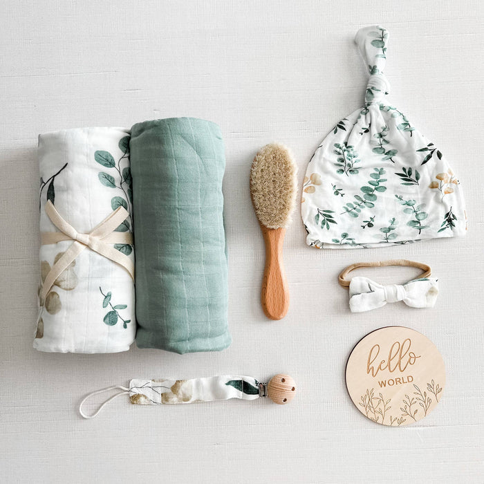 Coco Stripes Eucalyptus Baby Shower Gift Set with bamboo-cotton items: swaddles, hat, brush, and accessories in a neutral palette.