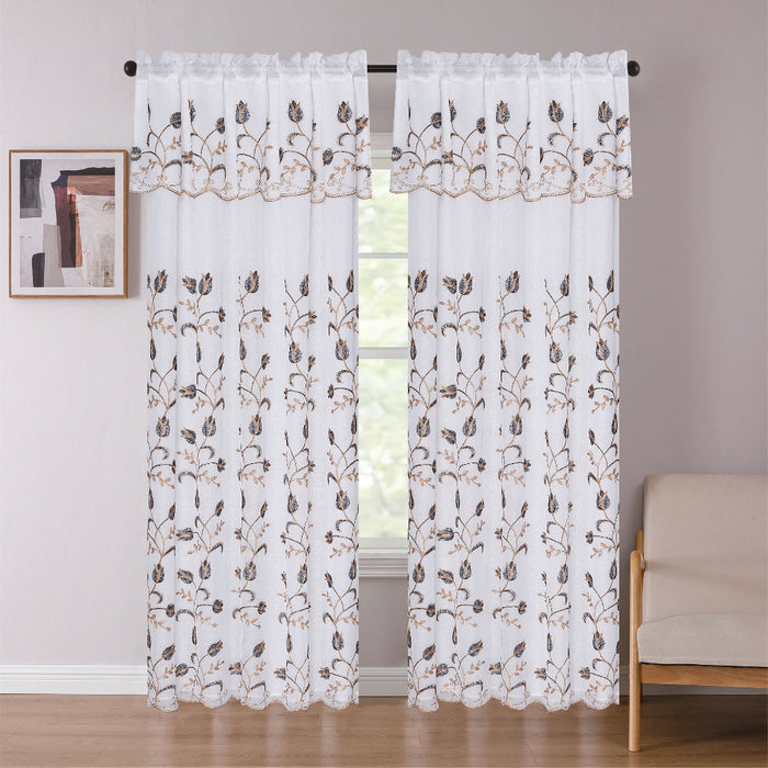 Sheer curtains with floral embroidery in a room with a window and beige sofa.