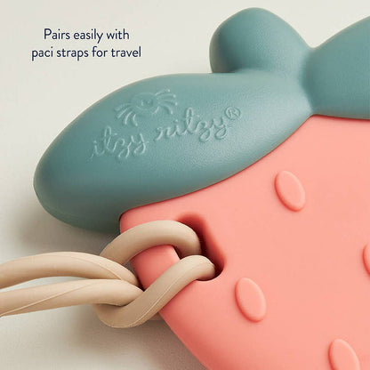 Close-up of Slicone Teething Rattle Strawberry Sweetie Shake™, showing blue and pink silicone with paci strap compatibility.