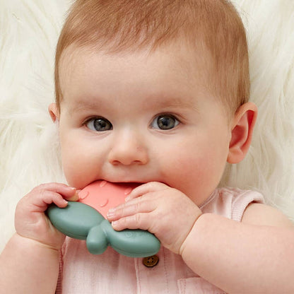Baby using Slicone Teething Rattle Strawberry Sweetie Shake for soothing tender gums.